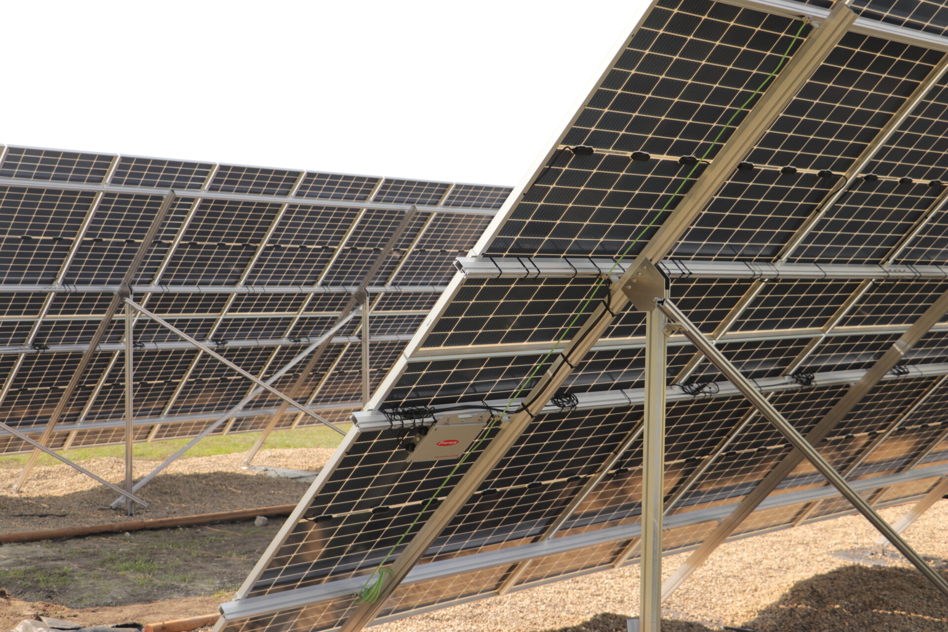 This image shows a set of solar panels installed on metal frames, arranged at an angle to capture sunlight for renewable energy generation.