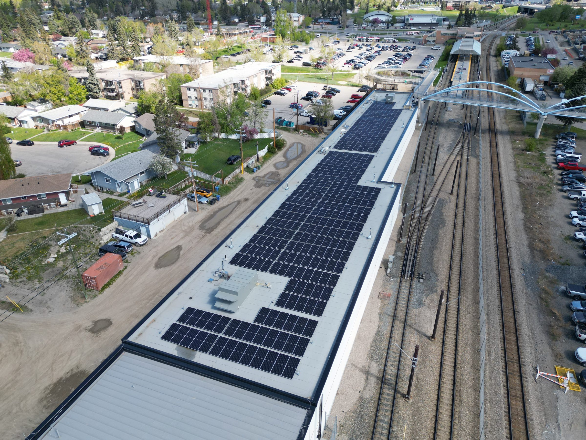 Aerial view of a professional solar panel installation and new roofing system integrated by Rocky Mountain Solar Co. in Calgary.