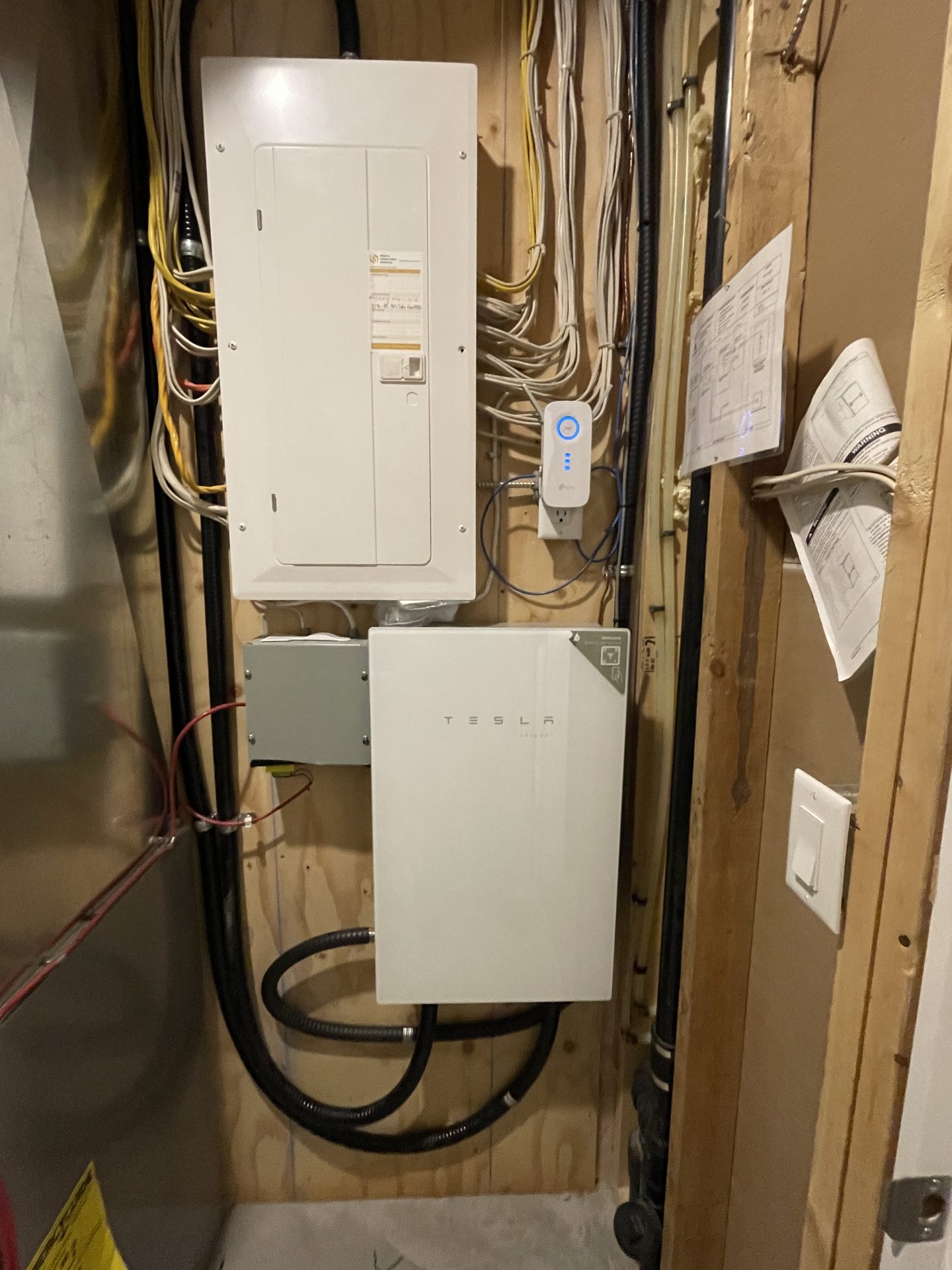 Interior Tesla Powerwall Calgary installation featuring the Gateway 2 and backup electrical panel.