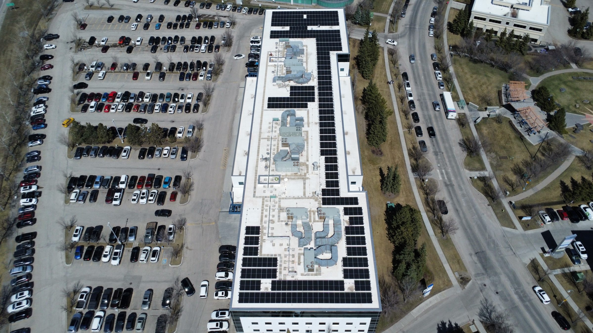 Commercial flat-roof solar array in SE Calgary integrated with a full Lynnwood Roofing re-roof for maximum warranty protection.