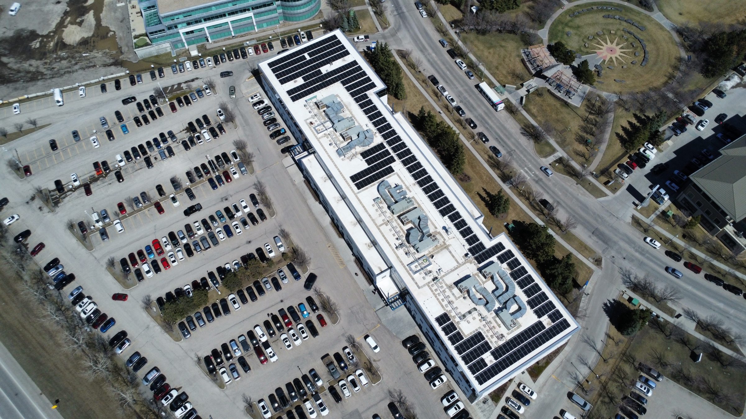 Commercial solar panel mounting and racking system installed on a new flat roof membrane in Calgary.