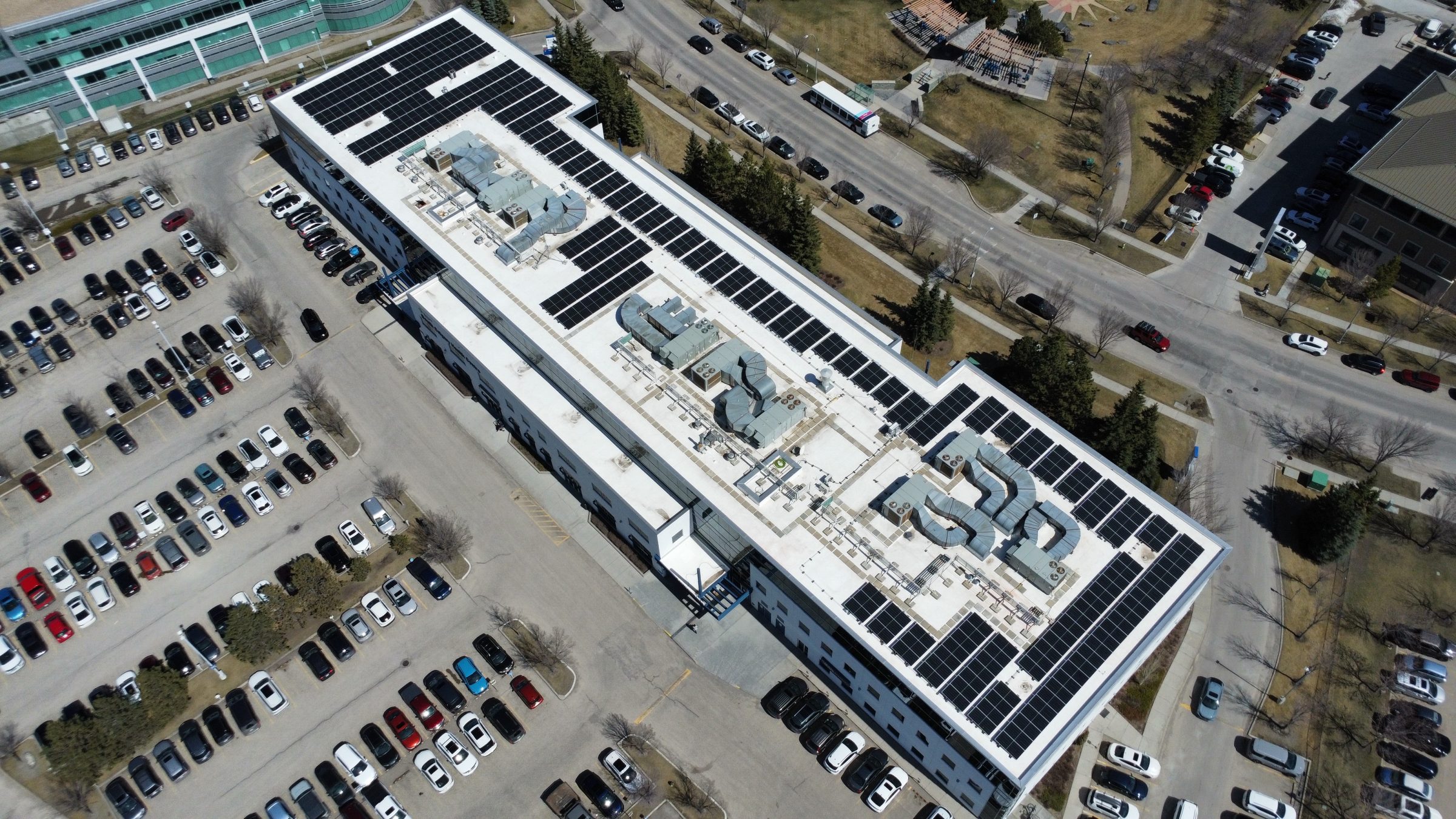 Commercial solar panel installation in Calgary by Rocky Mountain Solar Co. featuring a professional re-roofing project completed by Lynnwood Roofing.