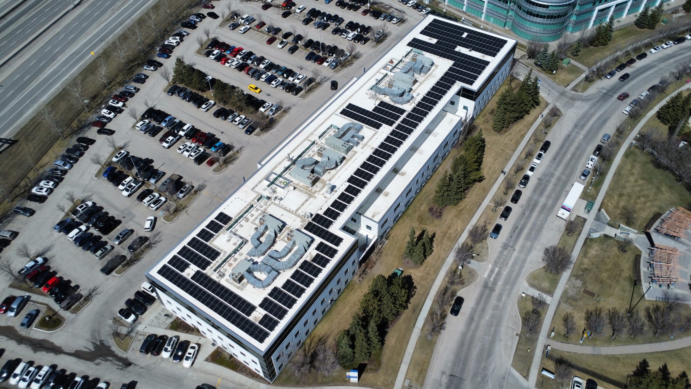 Aerial view of a professional solar panel installation and new roofing system integrated by Rocky Mountain Solar Co. in Calgary.